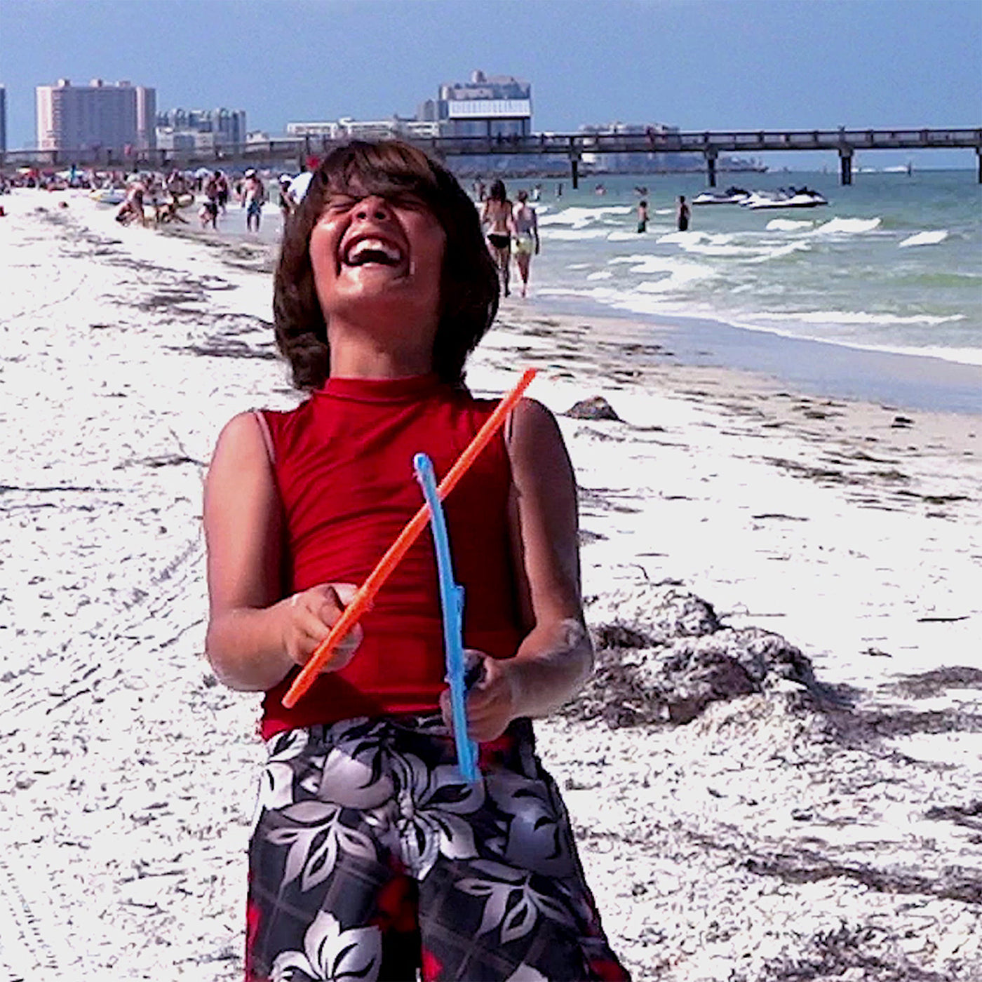 Kid laughing having fun playing RingStix at the beach