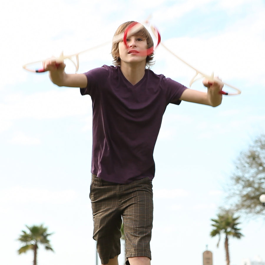 Boy playing RingStix at the park focused