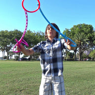 Boy playing RingStix in the park having fun