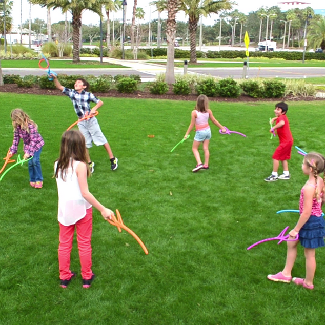 Group of kids playing RingStix at the park