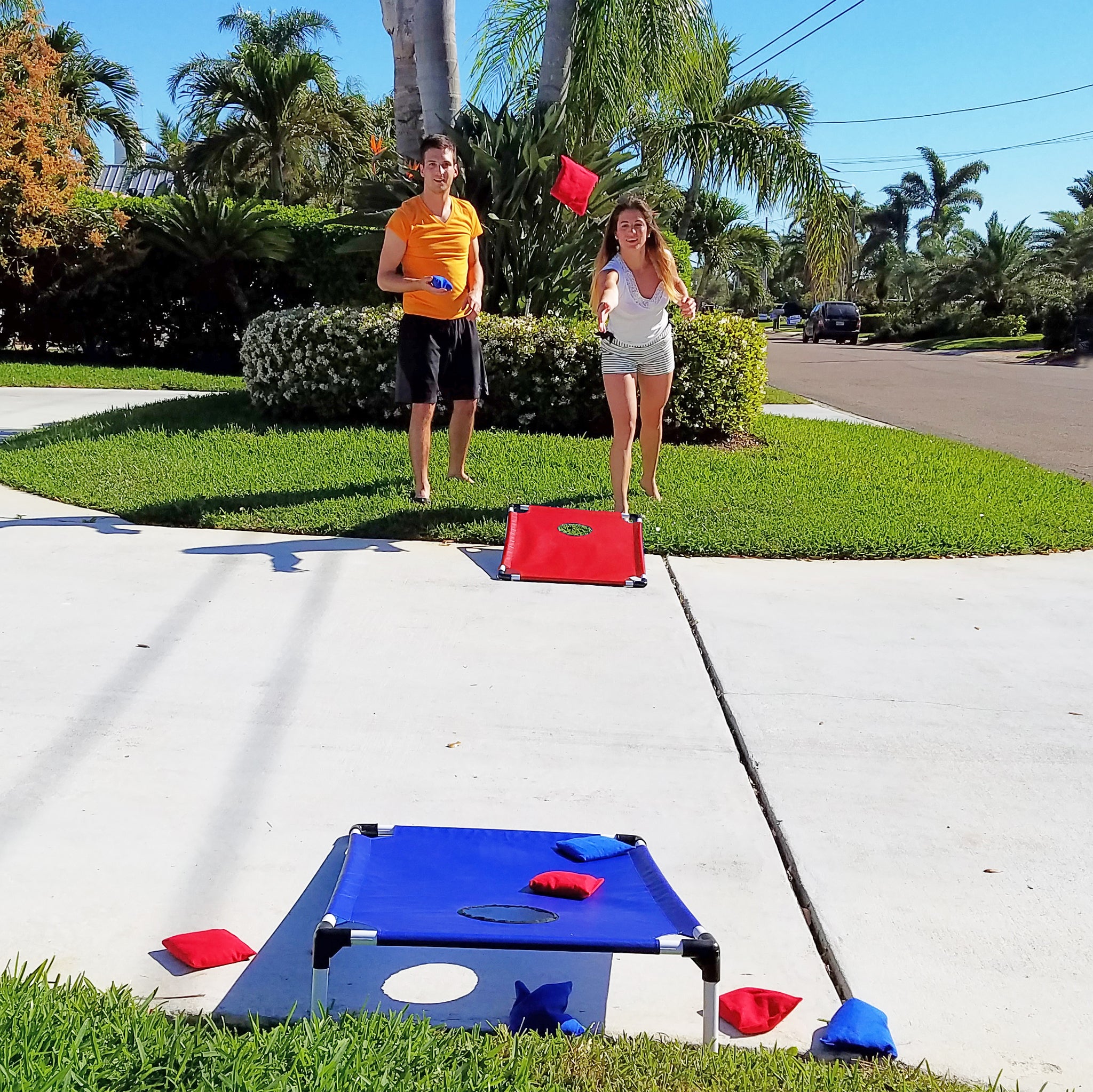 Siblings playing Cornhole Bean Bag game by Funsparks