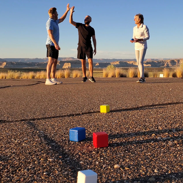 Family enjoying Bocce outdoors for camping games