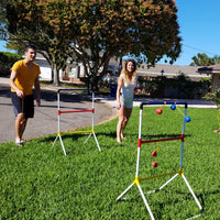 siblings playing ladder golf set in front yard