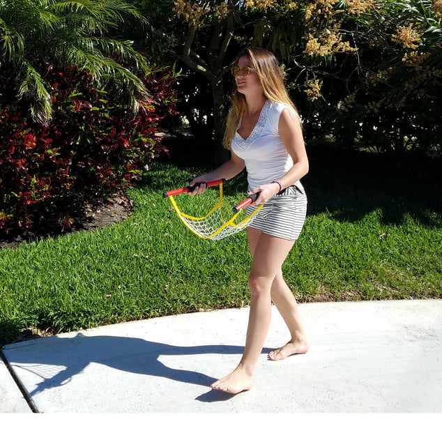 Teen girl playing Switch Ball in the front yard