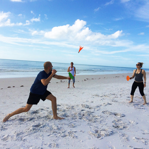 Friends playing Jazzminton at the beach