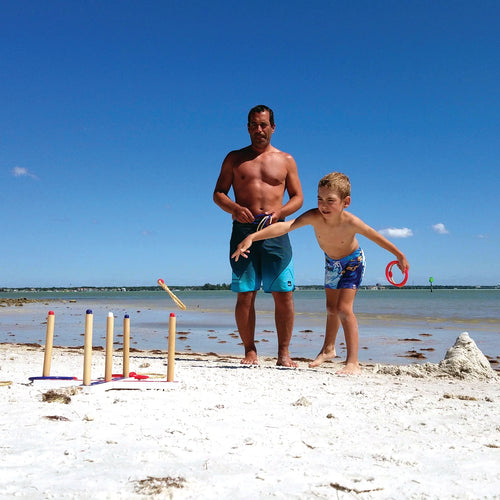 Dad and son playing Ring Toss at the beach having fun by Funsparks