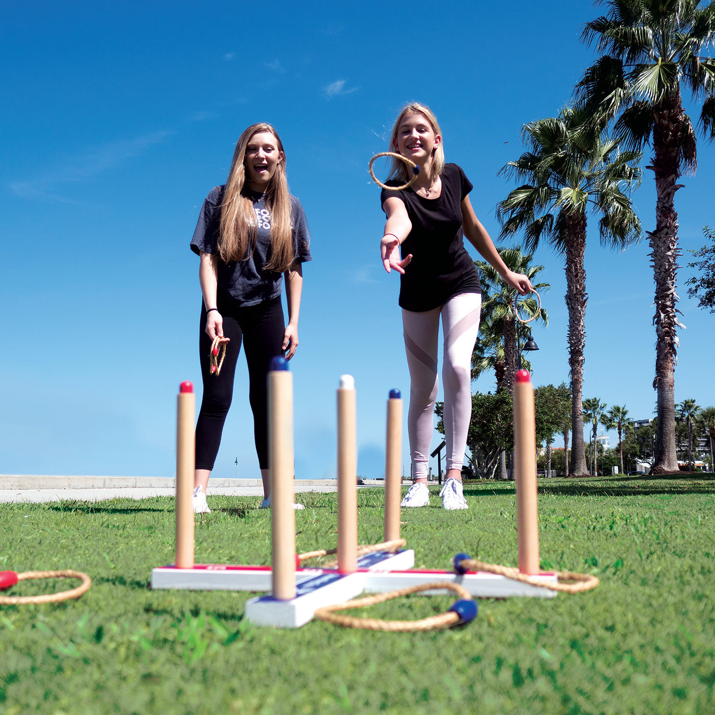 Friends playing Ring Toss Deluxe by Funsparks at the park