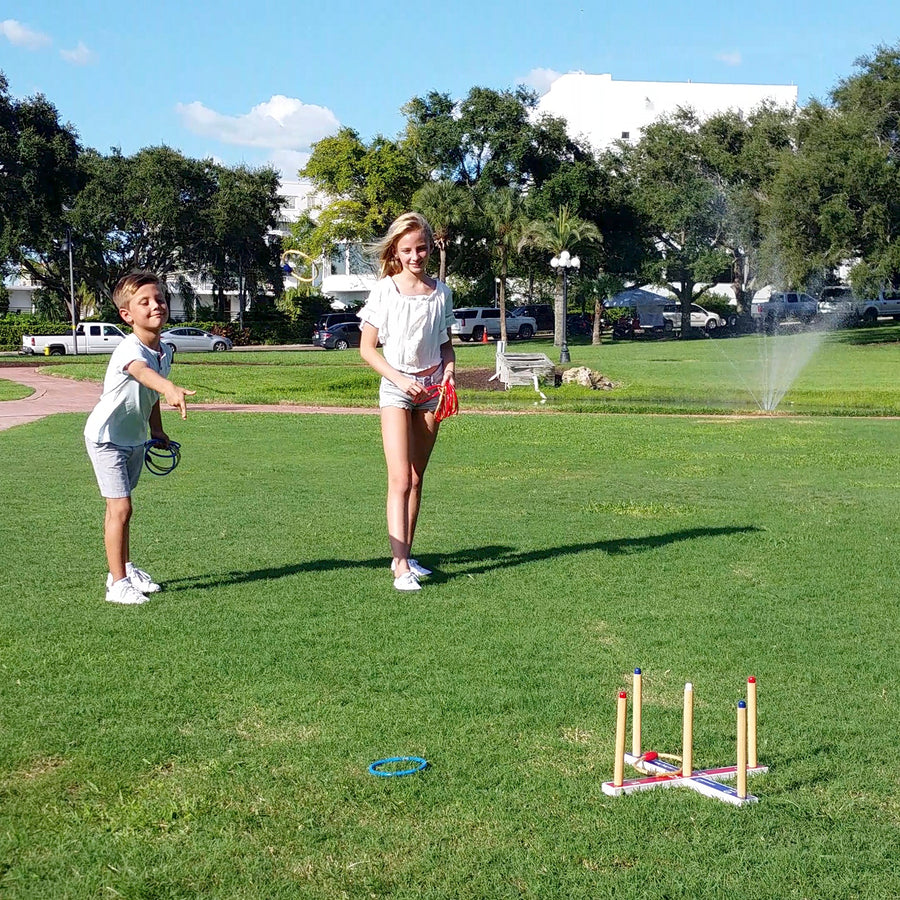 Siblings playing Ring Toss at the park having fun