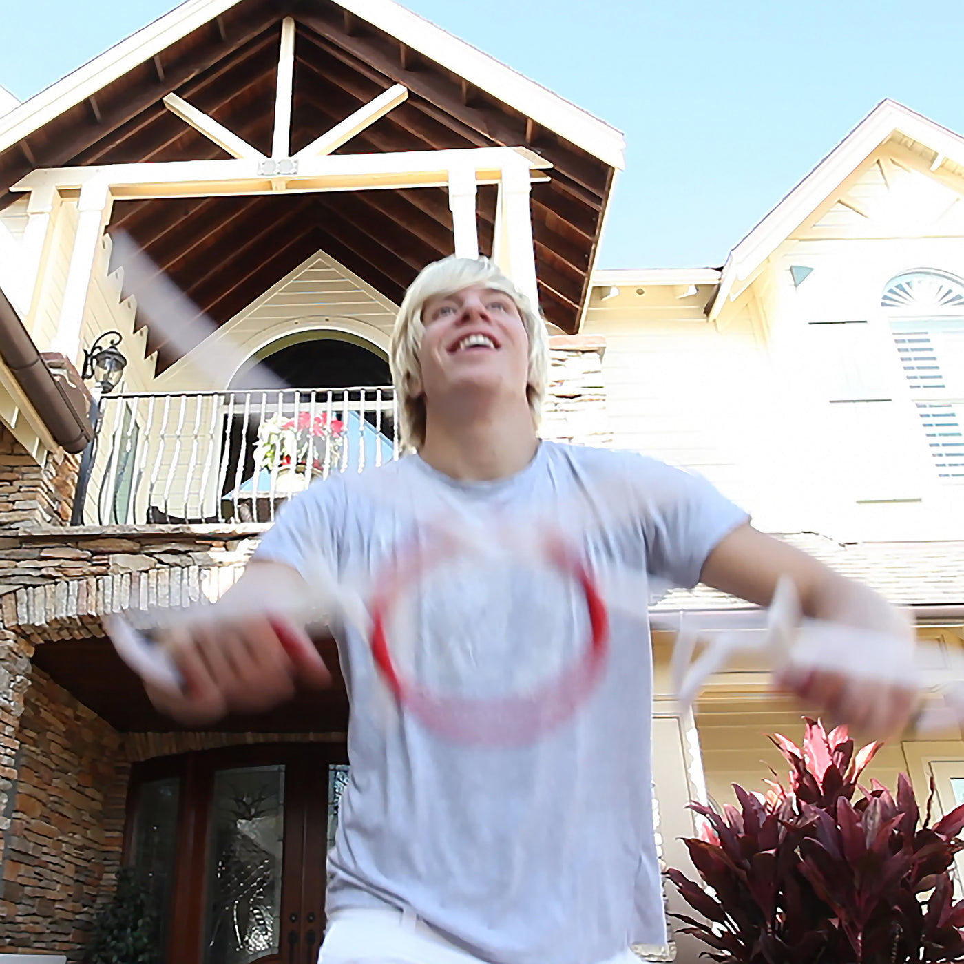 teen having fun shooting RingStix in front yard